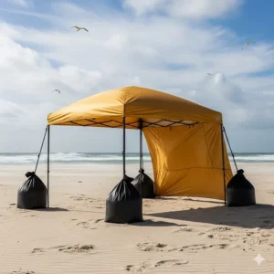 A beach tent remains stable and secure on a windy day, thanks to the heavy-duty sand bags holding it in place.