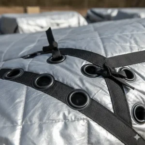 A detailed image showing the reinforced grommets on an insulated tarp, emphasizing its durability and easy tie-down points.