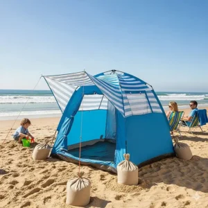 Sand bags are used to anchor a compact, pop-up beach tent, highlighting their versatility and convenience.
