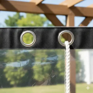 Close-up of the reinforced grommets on a heavy-duty clear patio tarp for secure installation.