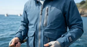 Close-up of a breathable rain jacket for fishing featuring sealed zippers and deep pockets.