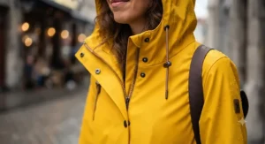 Close-up of the hood and waterproof material on a women's iconic yellow rain jacket.