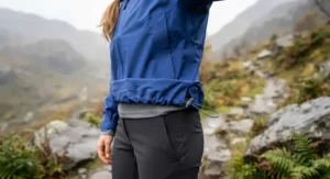 Showing the adjustable hem on a rain jacket cinched properly to seal out wind and rain at the waist.