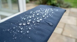 Water droplets beading up on a durable water repellent treated jacket shell