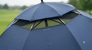 Close-up view of the double canopy venting system on a large windproof golf umbrella to resist high gusts.