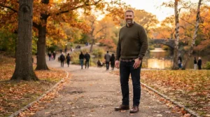 A big and tall man relaxing outdoors comfortably in a down jacket for tall men.