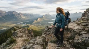 A mountaineer looking over a scenic overlook in Colorado wearing a high-performance 800 fill down jacket.